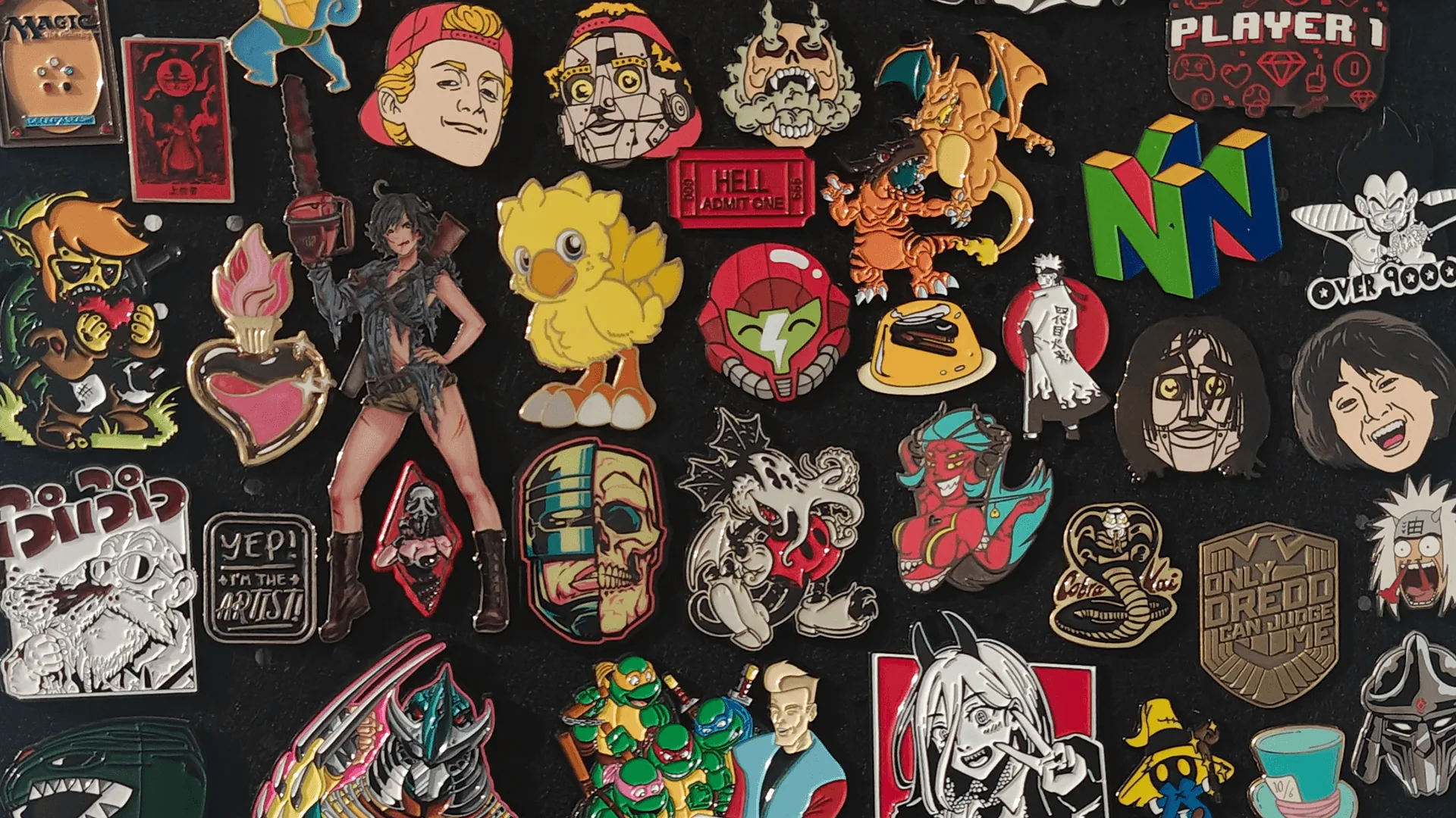 Enamel pins laid out on a table, phone in hand, about to photograph them